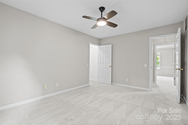 6434 Skyline Dr, Charlotte, NC 28269 - unfurnished bedroom with baseboards, light carpet, and ceiling fan