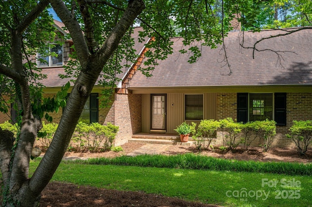 104 Ridge Dr, Stanley, NC 28164 - view of front of property featuring brick siding, a shingled roof, and a chimney