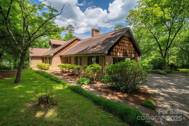 104 Ridge Dr, Stanley, NC 28164 - view of side of home featuring brick siding, a chimney, and a lawn