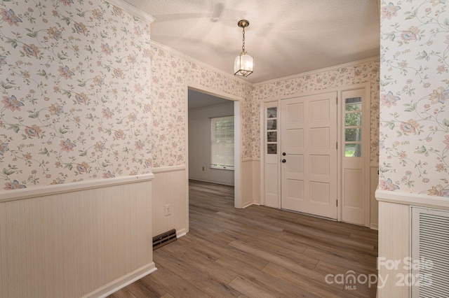 104 Ridge Dr, Stanley, NC 28164 - entryway featuring wallpapered walls, a wainscoted wall, crown molding, and dark wood-type flooring