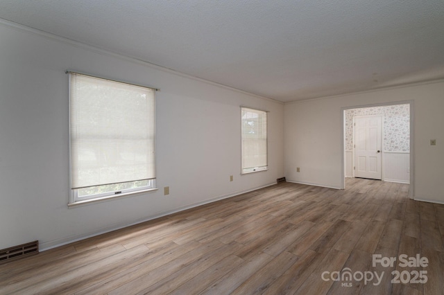 104 Ridge Dr, Stanley, NC 28164 - unfurnished room with plenty of natural light, wood finished floors, and ornamental molding