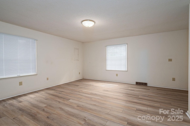 104 Ridge Dr, Stanley, NC 28164 - spare room featuring light wood finished floors, baseboards, and a textured ceiling