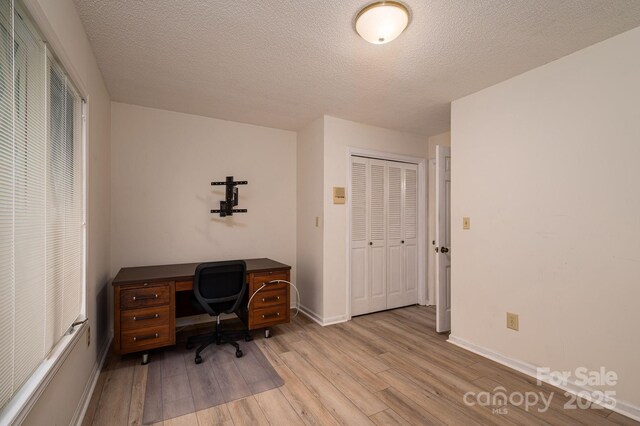 104 Ridge Dr, Stanley, NC 28164 - home office featuring light wood finished floors, baseboards, and a textured ceiling