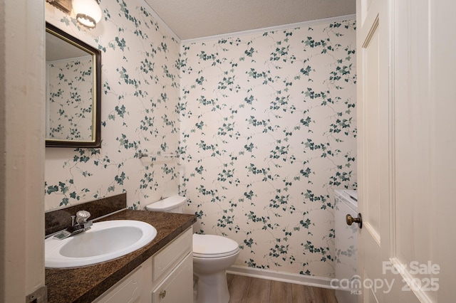 104 Ridge Dr, Stanley, NC 28164 - bathroom featuring wallpapered walls, toilet, wood finished floors, vanity, and a textured ceiling