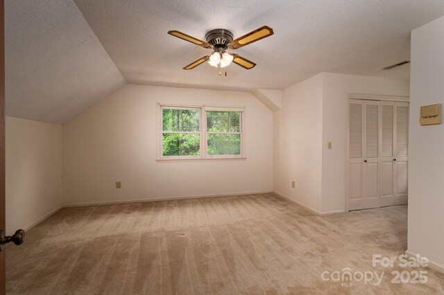 104 Ridge Dr, Stanley, NC 28164 - additional living space featuring carpet flooring, a textured ceiling, ceiling fan, vaulted ceiling, and baseboards