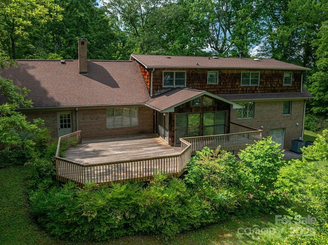 104 Ridge Dr, Stanley, NC 28164 - back of house with a chimney, central AC unit, a wooden deck, and brick siding