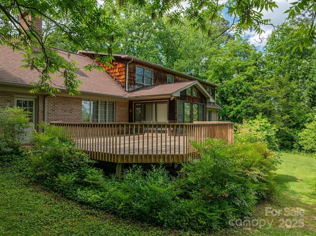 104 Ridge Dr, Stanley, NC 28164 - back of property featuring brick siding, a deck, a chimney, a shingled roof, and a yard