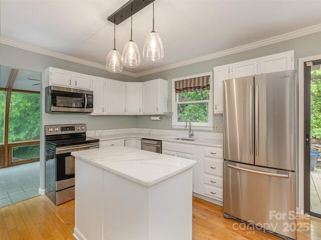 55 Willow Bnd, Hendersonville, NC 28792 - kitchen with stainless steel appliances, a sink, white cabinets, light wood finished floors, and ornamental molding