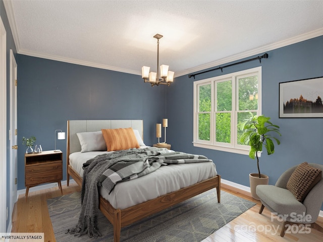 55 Willow Bnd, Hendersonville, NC 28792 - bedroom featuring wood finished floors, ornamental molding, a chandelier, and baseboards