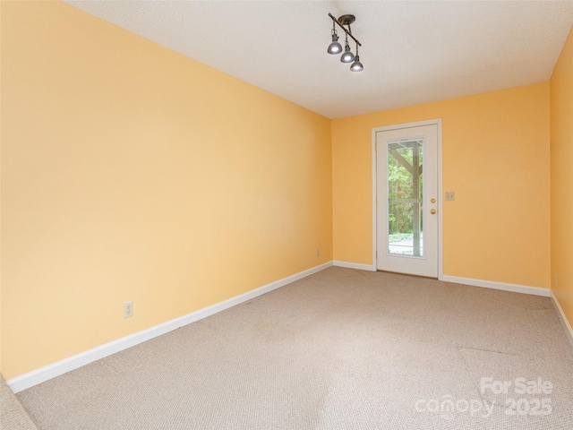 55 Willow Bnd, Hendersonville, NC 28792 - unfurnished room featuring light carpet, baseboards, and rail lighting
