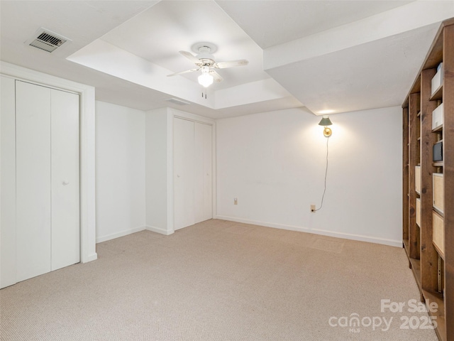 55 Willow Bnd, Hendersonville, NC 28792 - unfurnished bedroom with a tray ceiling, light colored carpet, baseboards, and multiple closets