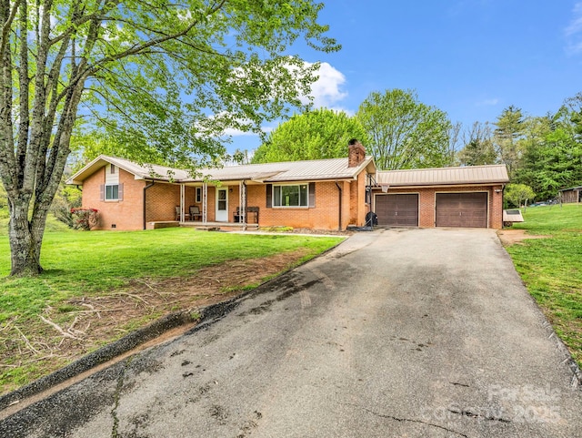 ranch-style house featuring a chimney, brick siding, a garage, a porch, and driveway