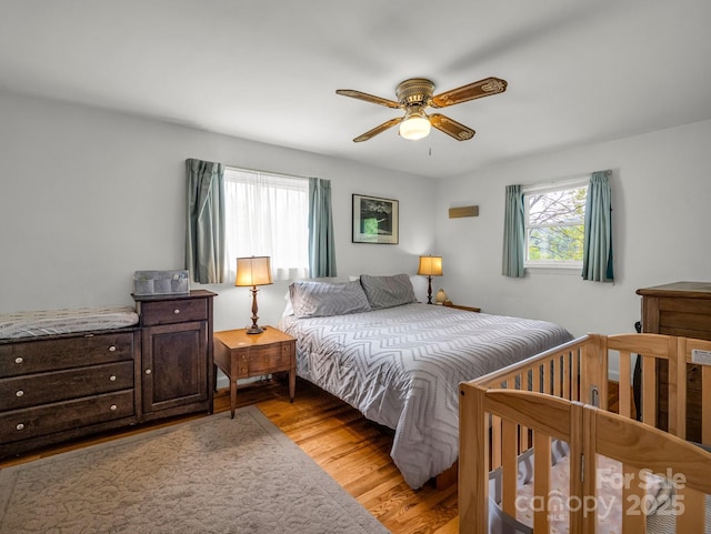bedroom featuring light wood-style flooring and ceiling fan