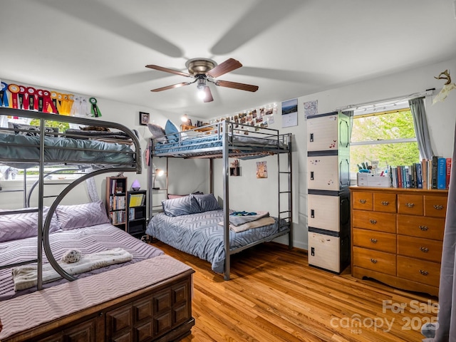 bedroom with light wood-style flooring and a ceiling fan