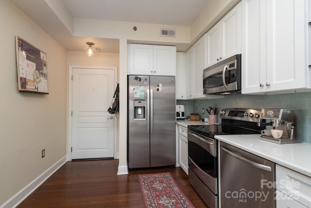1320 Fillmore Ave Unit 426, Charlotte, NC 28203 - kitchen with stainless steel appliances, light countertops, white cabinets, and dark wood finished floors