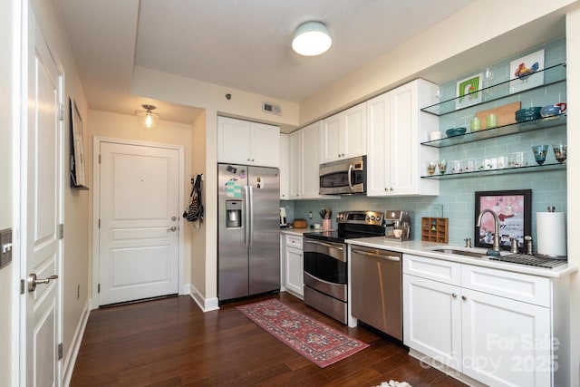 1320 Fillmore Ave Unit 426, Charlotte, NC 28203 - kitchen with stainless steel appliances, a sink, light countertops, white cabinetry, and tasteful backsplash