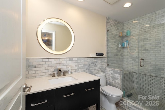 1320 Fillmore Ave Unit 426, Charlotte, NC 28203 - bathroom with tile walls, toilet, a shower stall, vanity, and recessed lighting