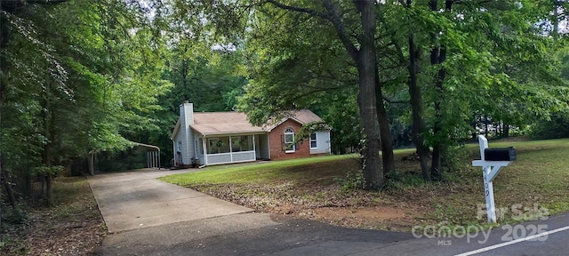 4409 Homestead Rd, Rock Hill, SC 29732 - view of front of property featuring concrete driveway, brick siding, a chimney, and a front yard