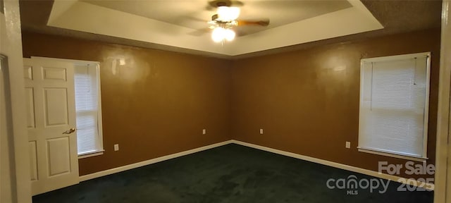 4409 Homestead Rd, Rock Hill, SC 29732 - empty room featuring baseboards, dark colored carpet, a tray ceiling, and ceiling fan