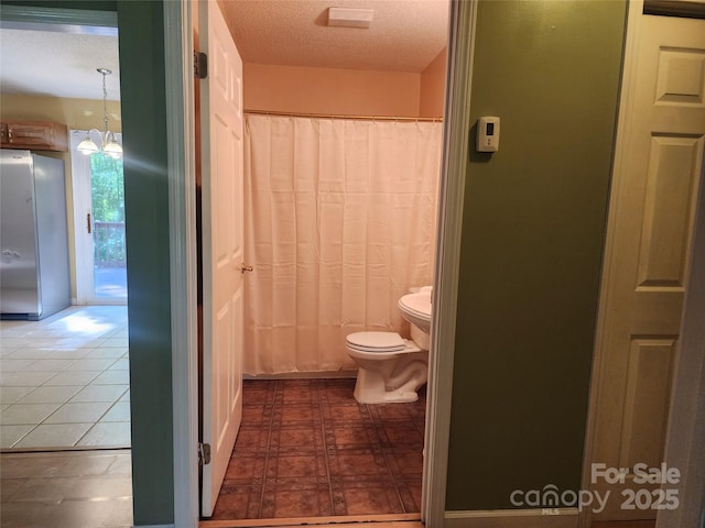 4409 Homestead Rd, Rock Hill, SC 29732 - bathroom with a shower with shower curtain, toilet, and a textured ceiling