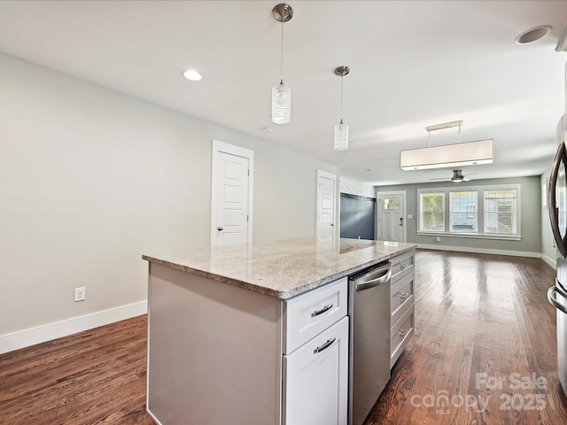 kitchen with dark wood-style floors, baseboards, open floor plan, decorative light fixtures, and light stone countertops