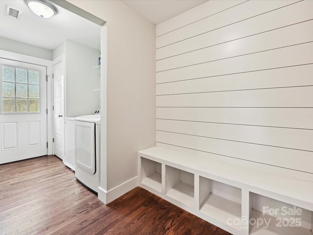 washroom featuring washer / dryer, dark wood-style flooring, and baseboards