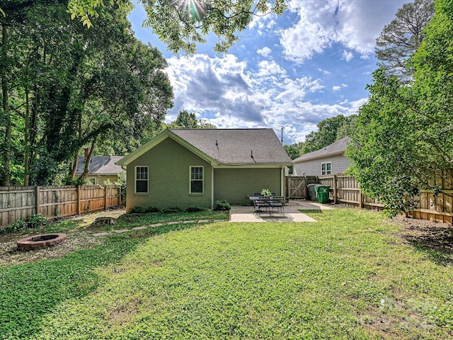 back of house featuring a fire pit, a patio, and stucco siding
