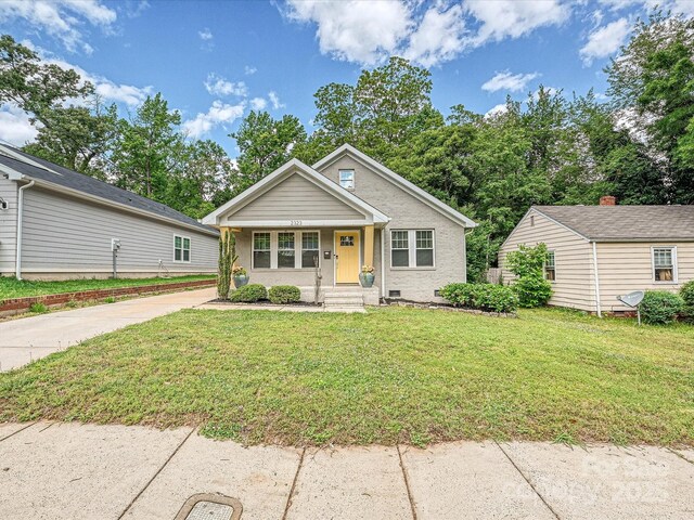 bungalow with a front yard