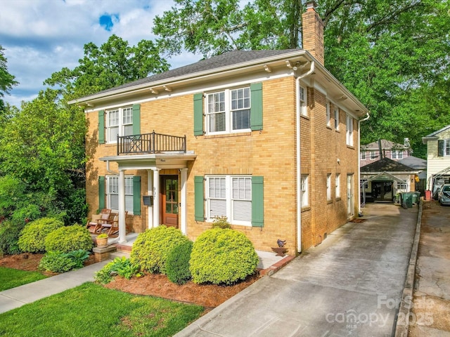 907 Edgewood Cir, Gastonia, NC 28052 - view of front of home with a balcony, a chimney, brick siding, and concrete driveway