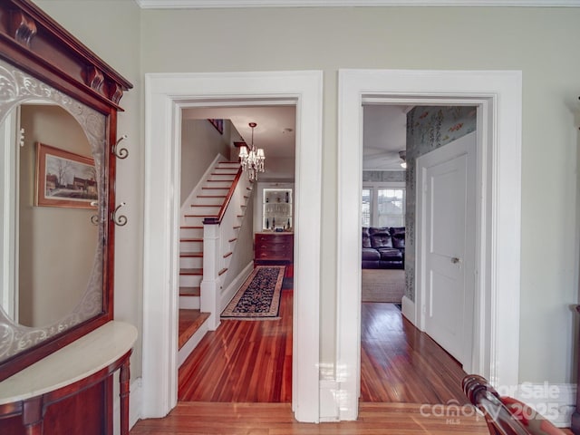 907 Edgewood Cir, Gastonia, NC 28052 - hallway featuring wood finished floors, stairway, and a chandelier