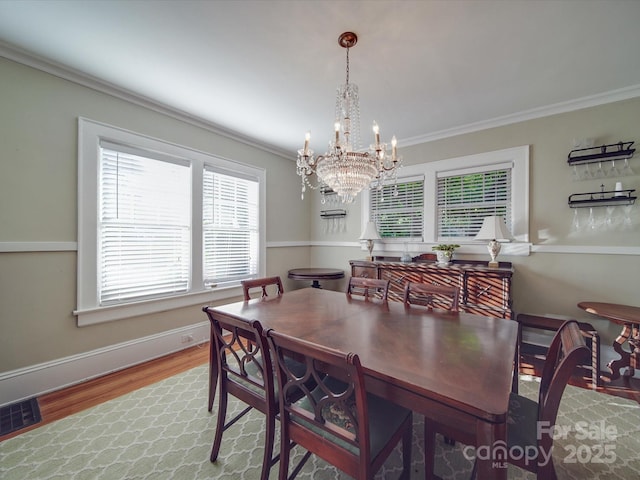 907 Edgewood Cir, Gastonia, NC 28052 - dining area with crown molding, wood finished floors, a chandelier, and baseboards