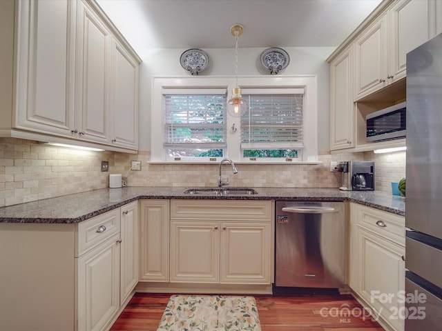 907 Edgewood Cir, Gastonia, NC 28052 - kitchen with stainless steel appliances, a sink, wood finished floors, and decorative backsplash