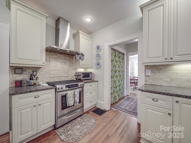 907 Edgewood Cir, Gastonia, NC 28052 - kitchen featuring gas range, wall chimney range hood, decorative backsplash, light wood finished floors, and recessed lighting