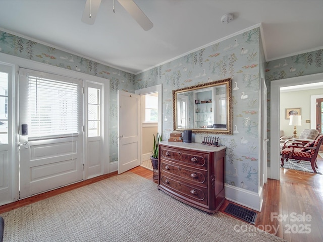 907 Edgewood Cir, Gastonia, NC 28052 - entrance foyer with light wood finished floors, ornamental molding, wallpapered walls, ceiling fan, and baseboards