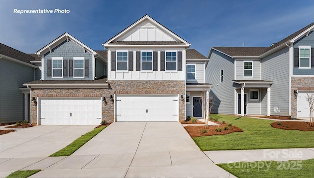 craftsman-style house with board and batten siding, driveway, an attached garage, stone siding, and a front lawn