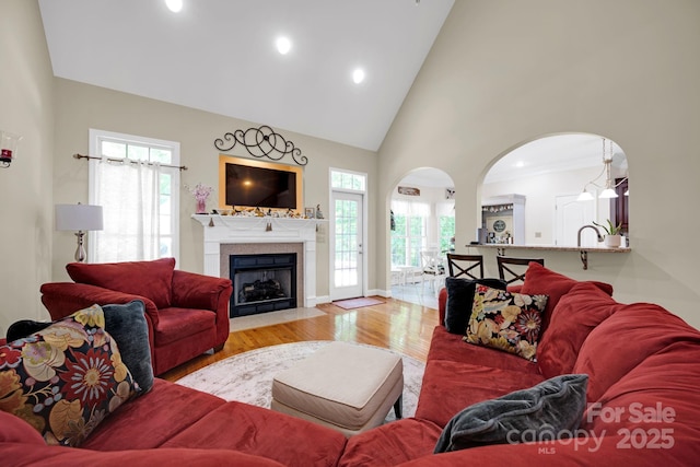 3610 Providence Mill Rd, Maiden, NC 28650 - living room featuring healthy amount of natural light, wood finished floors, arched walkways, a fireplace with flush hearth, and high vaulted ceiling