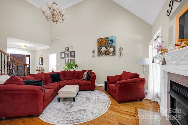 3610 Providence Mill Rd, Maiden, NC 28650 - living room with a chandelier, high vaulted ceiling, light wood finished floors, stairs, and a fireplace with flush hearth
