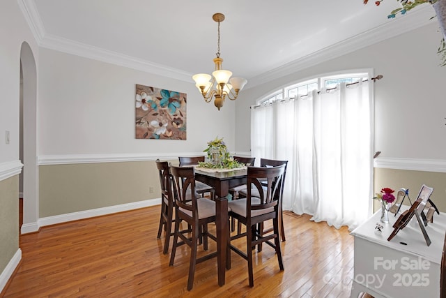 3610 Providence Mill Rd, Maiden, NC 28650 - dining room featuring arched walkways, light wood-style floors, a chandelier, crown molding, and baseboards