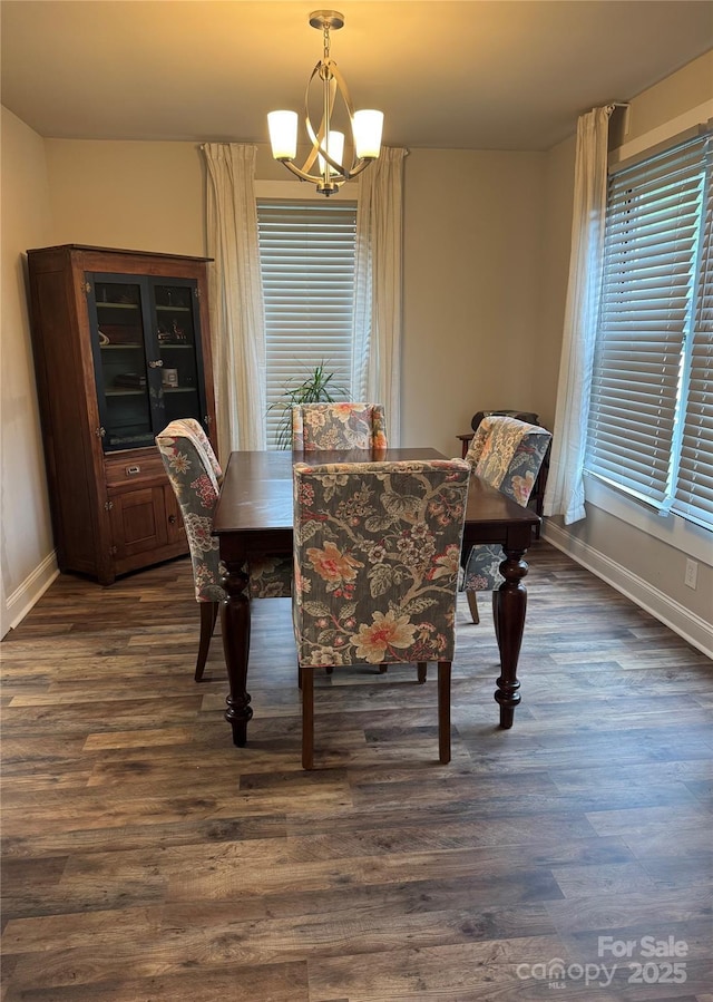 247 E Cabarrus Ave, Concord, NC 28025 - dining area featuring dark wood-style floors and a chandelier