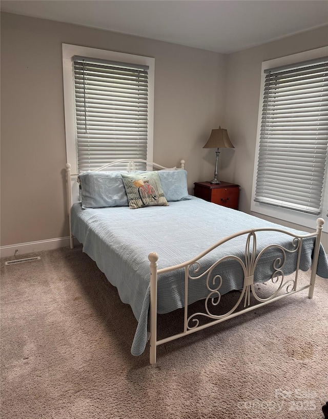 247 E Cabarrus Ave, Concord, NC 28025 - carpeted bedroom featuring baseboards