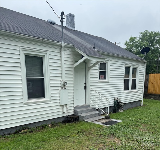 247 E Cabarrus Ave, Concord, NC 28025 - back of house with entry steps, roof with shingles, and a chimney