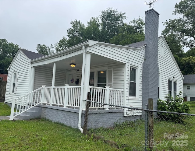 247 E Cabarrus Ave, Concord, NC 28025 - view of front of property featuring covered porch, a chimney, and roof with shingles