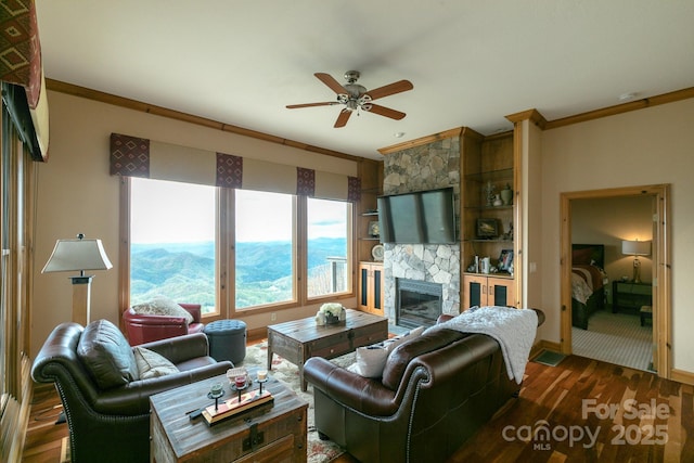 140 Slickrock Rd Unit F3, Burnsville, NC 28714 - living area featuring a ceiling fan, baseboards, crown molding, a fireplace, and dark wood-style floors