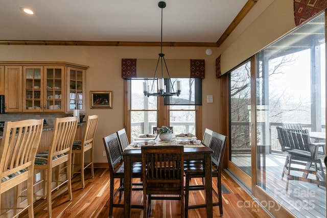 140 Slickrock Rd Unit F3, Burnsville, NC 28714 - dining area with wood finished floors, a healthy amount of sunlight, and a notable chandelier
