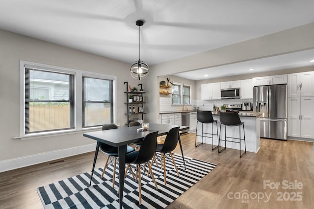 2212 Acme Rd, Belmont, NC 28012 - dining space featuring light wood-style floors, baseboards, and recessed lighting