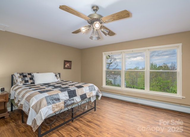 184 Buff Ridge Rd, Boone, NC 28607 - bedroom featuring baseboard heating, wood finished floors, and ceiling fan