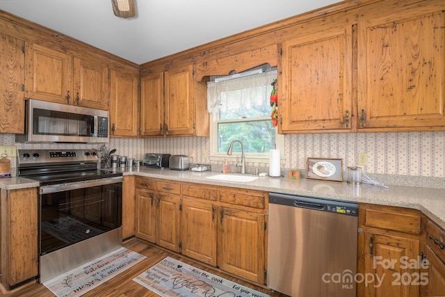 184 Buff Ridge Rd, Boone, NC 28607 - kitchen with stainless steel appliances, a sink, light countertops, and brown cabinetry