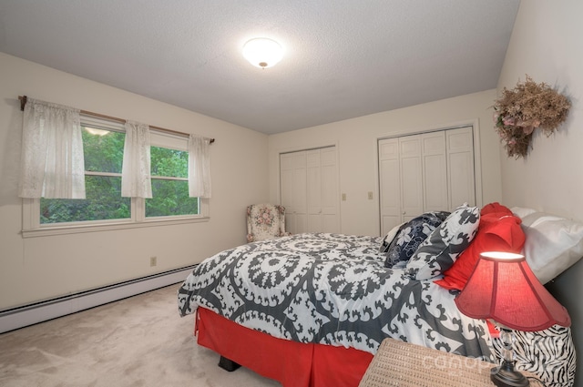 184 Buff Ridge Rd, Boone, NC 28607 - bedroom with a baseboard heating unit, multiple closets, carpet floors, and a textured ceiling