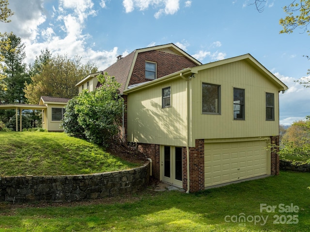 184 Buff Ridge Rd, Boone, NC 28607 - rear view of house featuring a garage, brick siding, and a yard