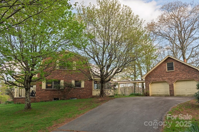 184 Buff Ridge Rd, Boone, NC 28607 - view of front of house with brick siding, a front yard, asphalt driveway, and a detached garage
